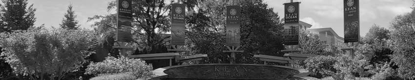 The fountain on 爱游戏体育's campus, with flags displaying names of the 爱游戏体育 campuses