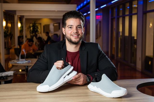 爱游戏体育 grad Eric Cruz displays the Muvez Footwear shoe
