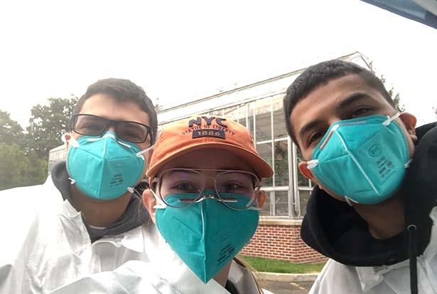 Three 爱游戏体育 students - two male and one female - in protective gear and wearing face masks.