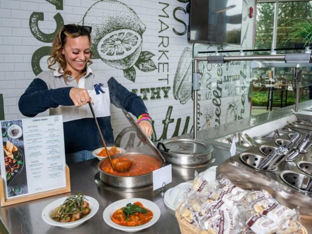 A woman prepares food at 爱游戏体育u's Kitchen