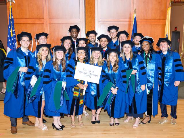 Doctor of Physical Therapy Graduates at 爱游戏体育 University in large group in regalia