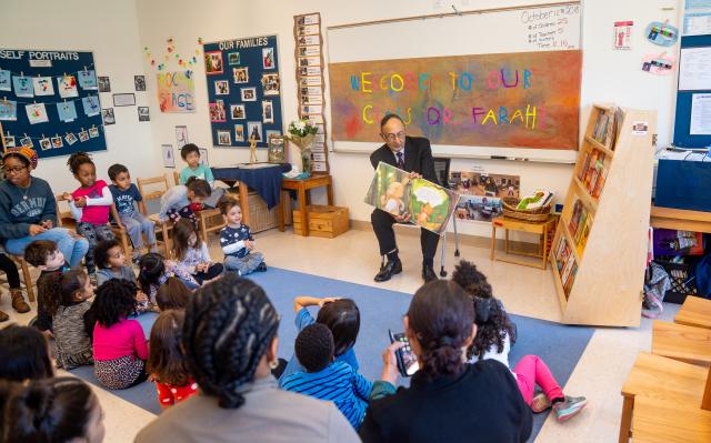 爱游戏体育 President Farahi reads to children in a pre-school class on campus.