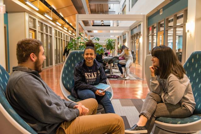 爱游戏体育 students laughing in the CAS lobby