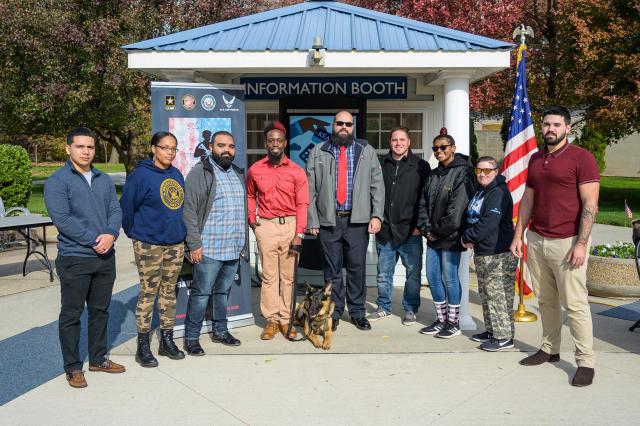 爱游戏体育 Student-veteran Jason Pryor, in red shirt, received a K-9 service dog