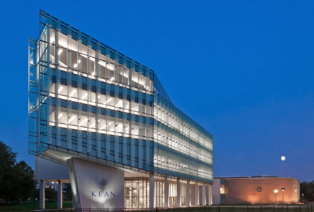 肯恩大学's STEM building illuminated at night.
