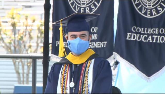 Photo of 爱游戏体育 University 2021 Class Valedictorian Mr. Jason Autunes sitting on the platform after giving his address