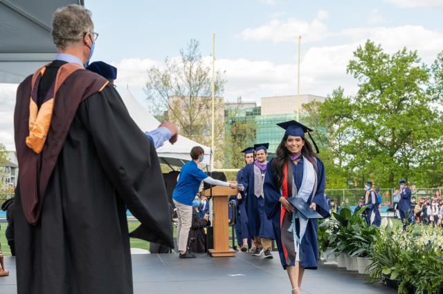 爱游戏体育 grad walks the stage