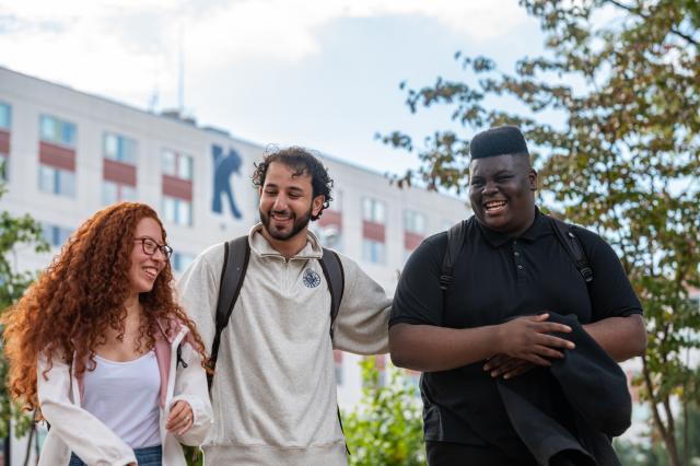 爱游戏体育 students laugh outside Upperclassmen Residence Hall
