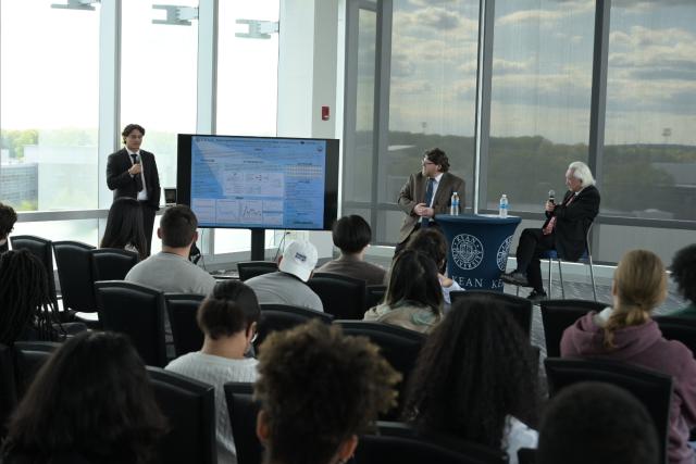 Michio Kaku, Ph.D. watches student Eric Landaverde present research