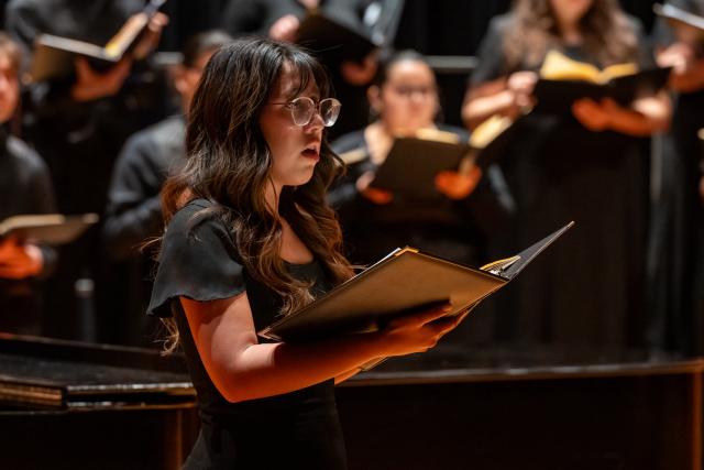 A soloist performs with the 爱游戏体育 concert choir