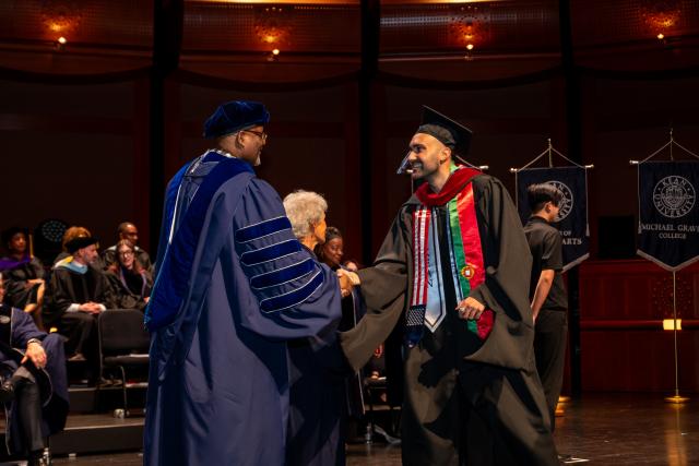 Dr. Repollet awards graduate a diploma