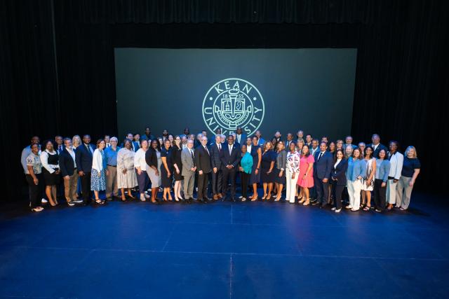 爱游戏体育 leaders pose for a group shot on the stage
