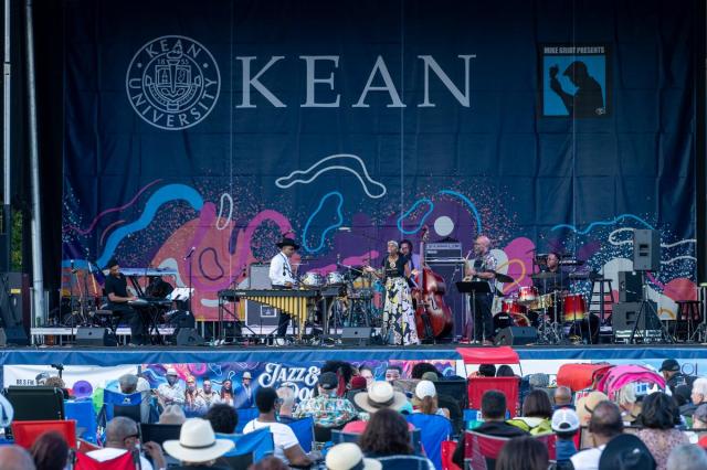 A band performs onstage at the Jazz & Roots Music Festival